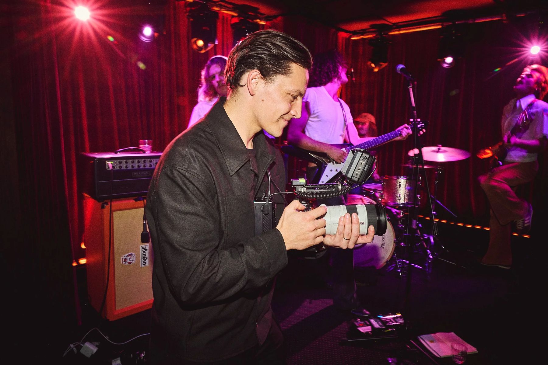Tom Anlezark filming a live band on stage