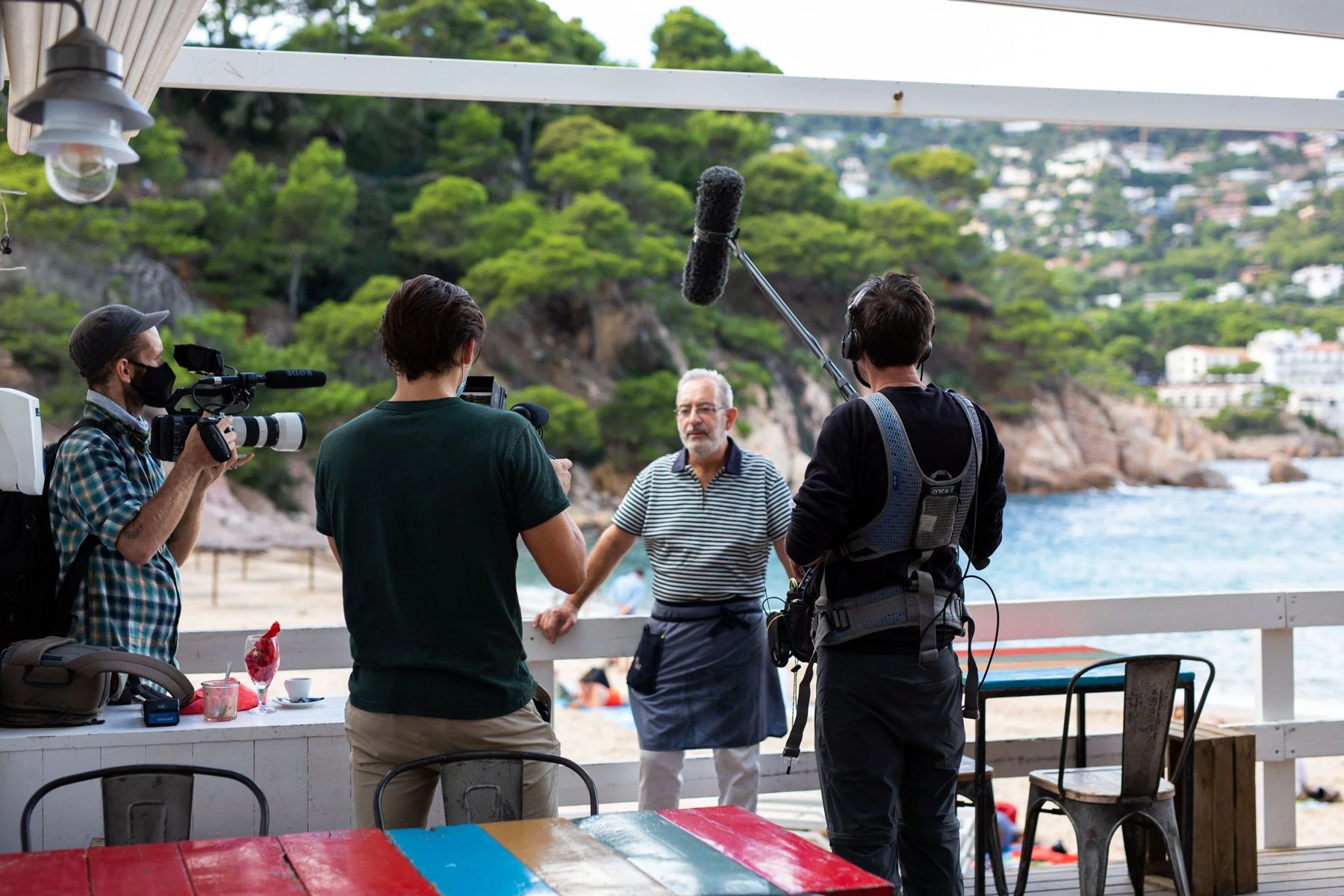 Culture Content crew filming an interview on a terrace by the sea