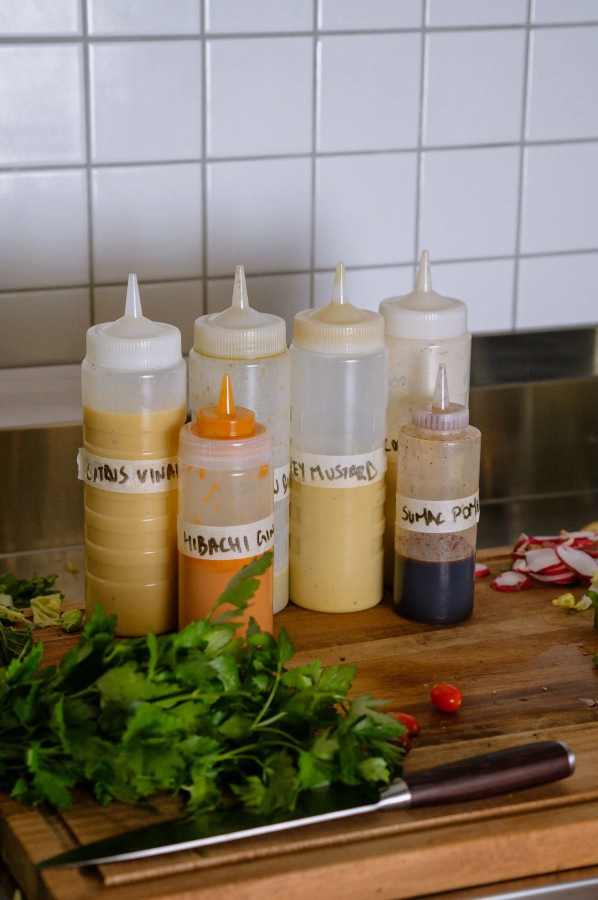 House made dressings labelled citrus vinaigrette, hibachi ginger, honey mustard and sumac pomegranate.