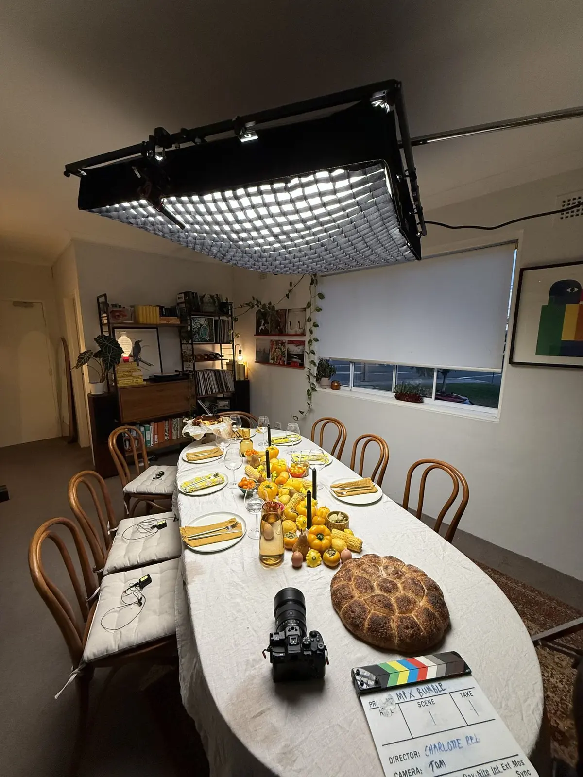 The gridded overhead softbox rigged above the yellow styled table before guests arrive.